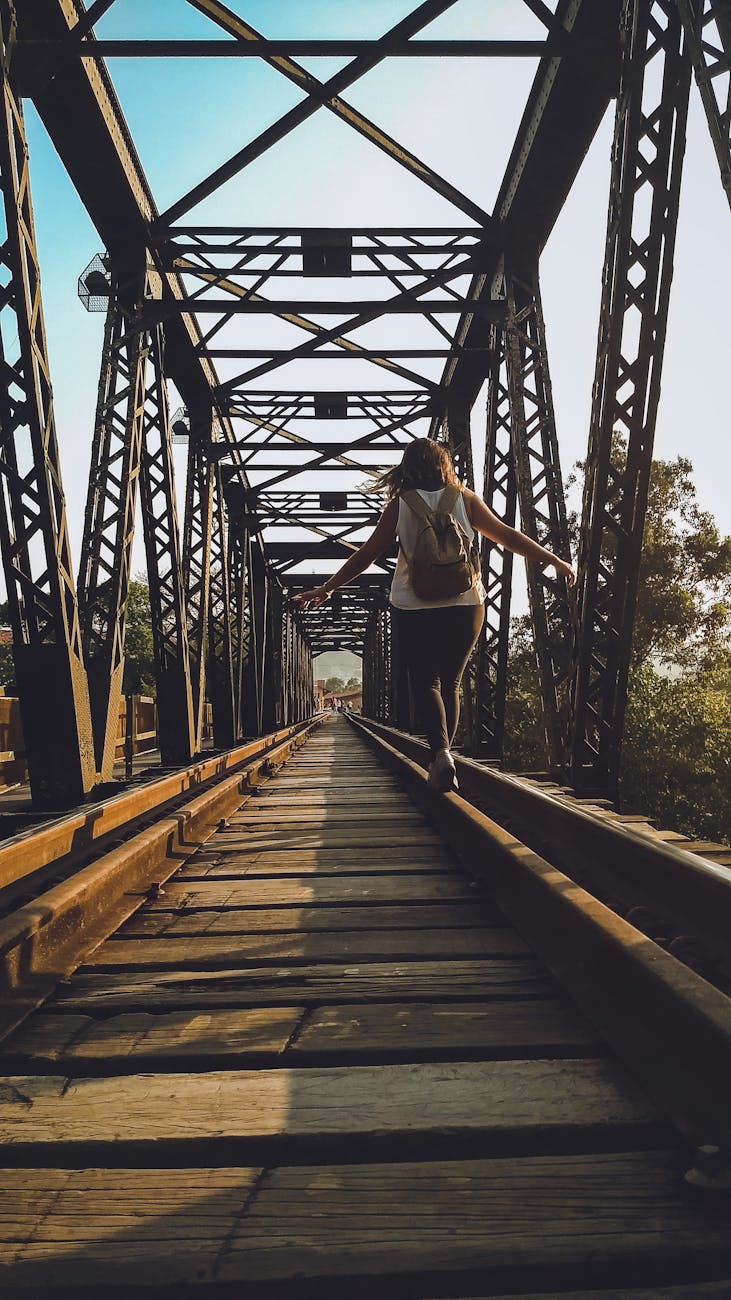 woman walking on a train rail